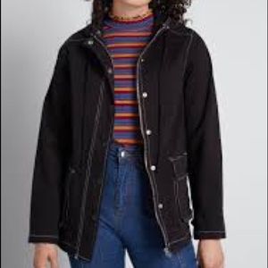 ModCloth Uncharted Territory Hooded Anorak Jacket in black with white stitching.